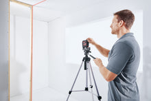 Load image into Gallery viewer, Man leveling laser on tripod